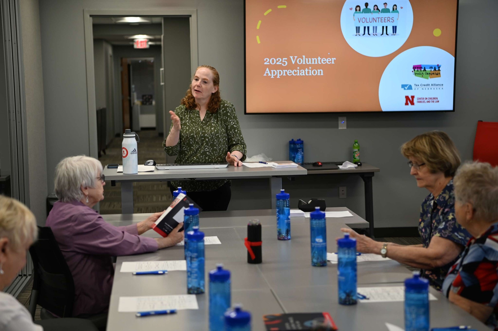 Katharina Stokes speaking to a room full of VITA volunteers. 