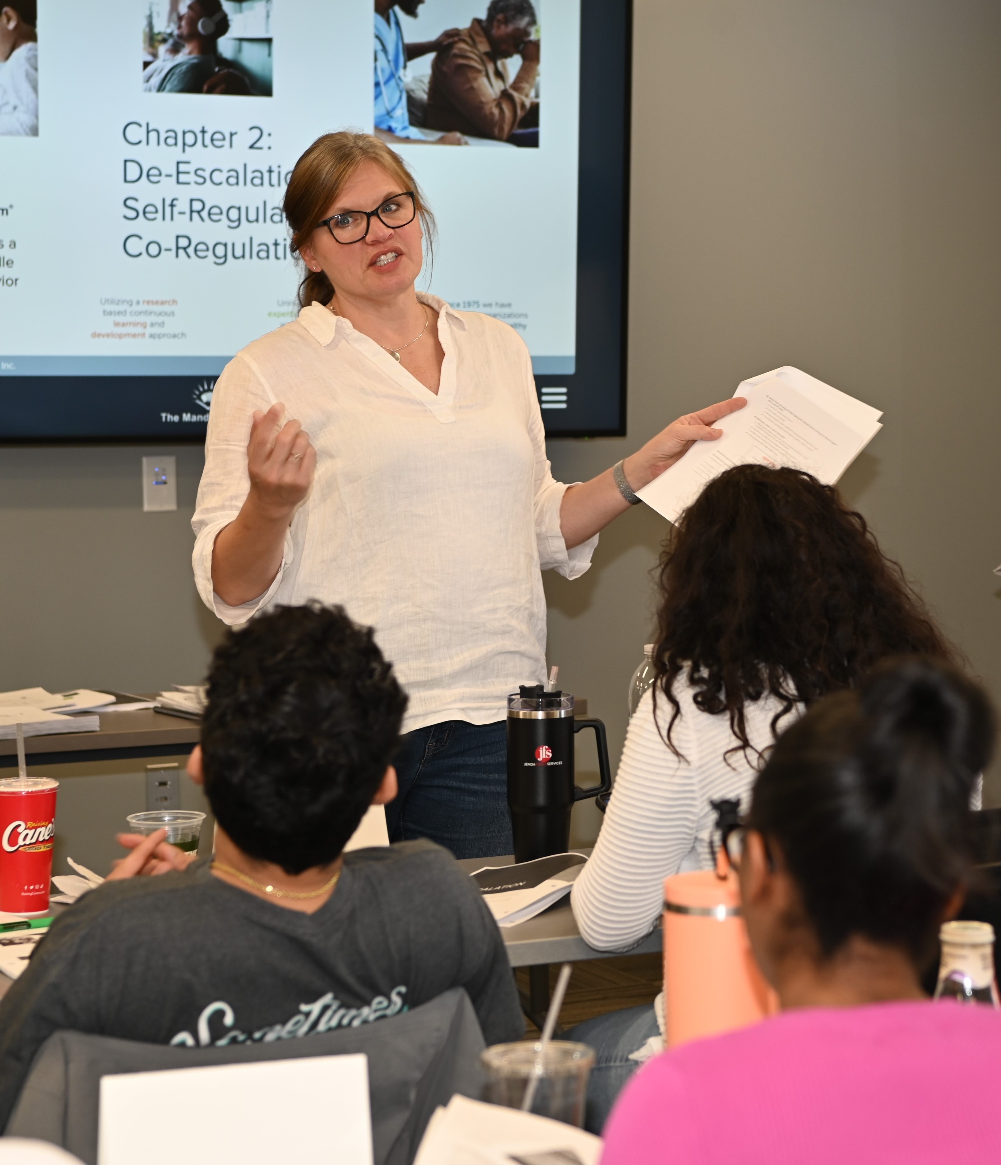 Jill Knox presenting a training to a room full of people