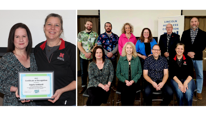 Two people holding a framed certificate of recognition, standing side by side indoors.